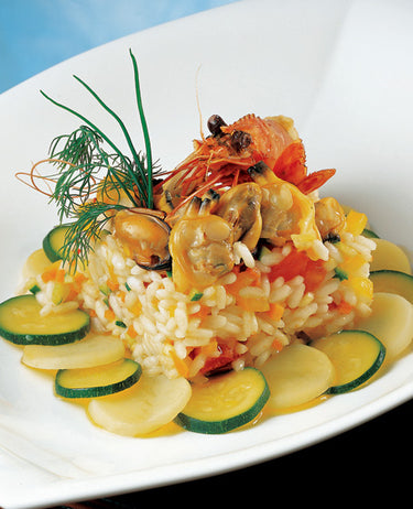 foto ricetta Riso di mare con verdurine su un letto di zucchini e patate 